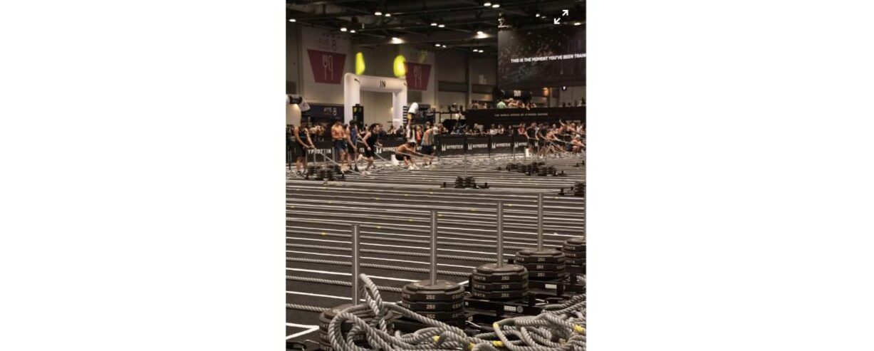 Is CrossFit right for me? Athletes doing a functional fitness competition with sleds and ropes, similar to Hyrox-style training
